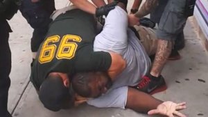 Eric Garner being hold by the NYPD. (image by Ramsey Orta - Time Magazine)