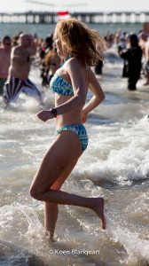 A woman runs in the cold water of the Atlantic Ocean during the coney island polar bear plunge